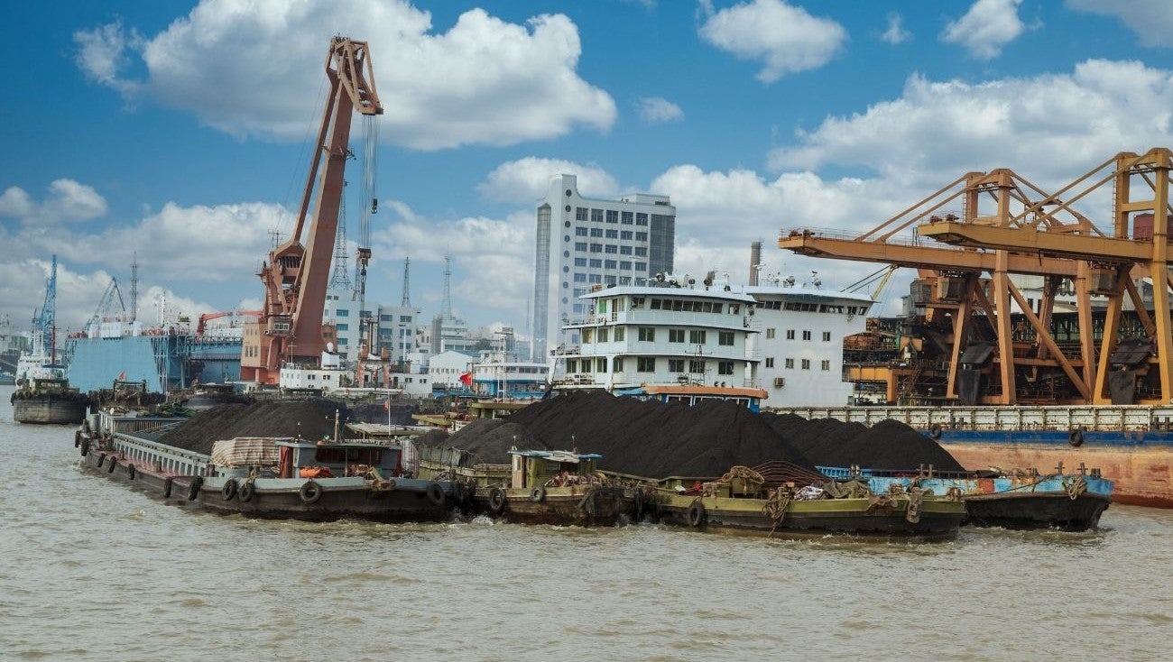 Rare earth metals (often used in renewable technologies) being loaded onto a cargo ship in China.
