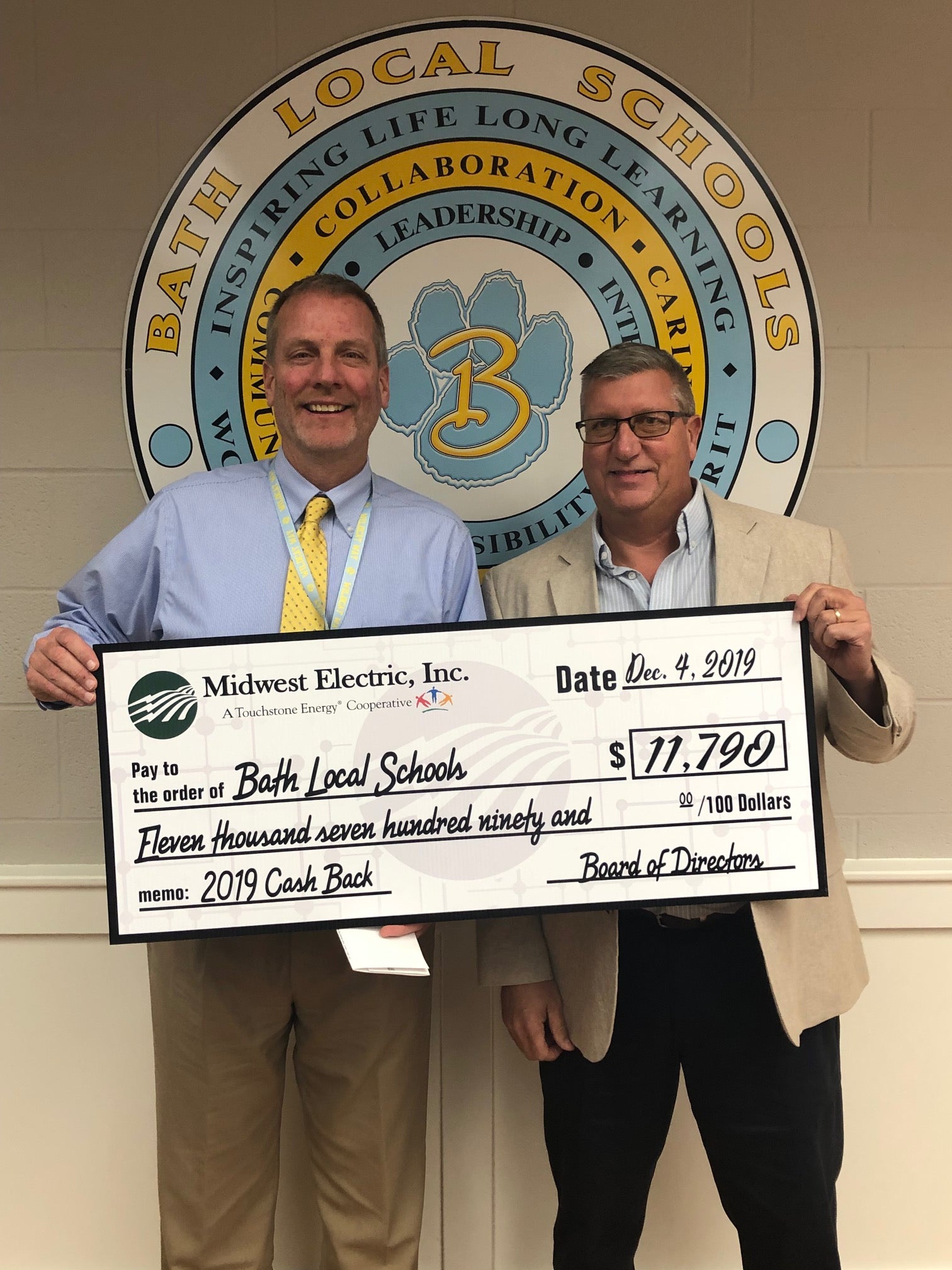 Rick%20Dackin%2C%20Superintendent%20for%20Bath%20School%20System%2C%20with%20Midwest%20Electric%20Dave%20Waltermire%20handing%20out%20capital%20credits%20checks%202019.jpg